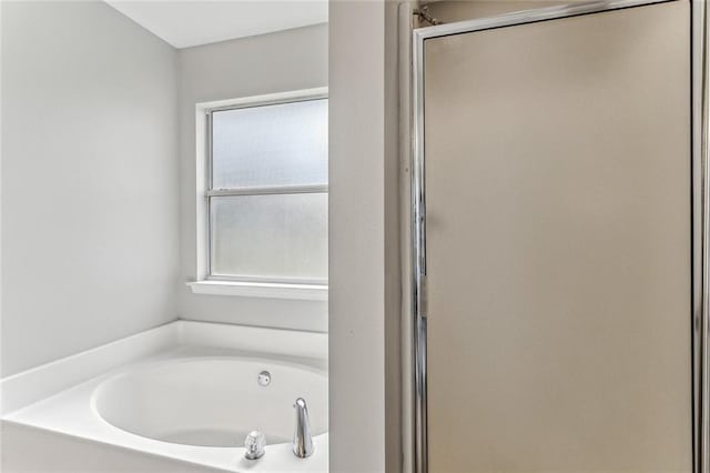 bathroom with separate shower and tub