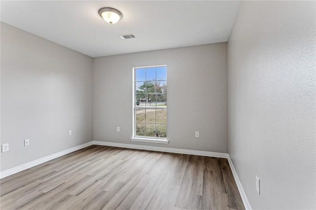 unfurnished room with light hardwood / wood-style floors