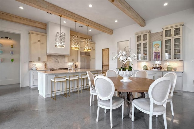 dining room featuring beamed ceiling