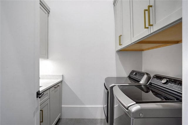 laundry room with cabinets and washer and dryer