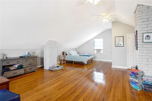 bedroom featuring ornate columns, lofted ceiling, hardwood / wood-style floors, and ceiling fan