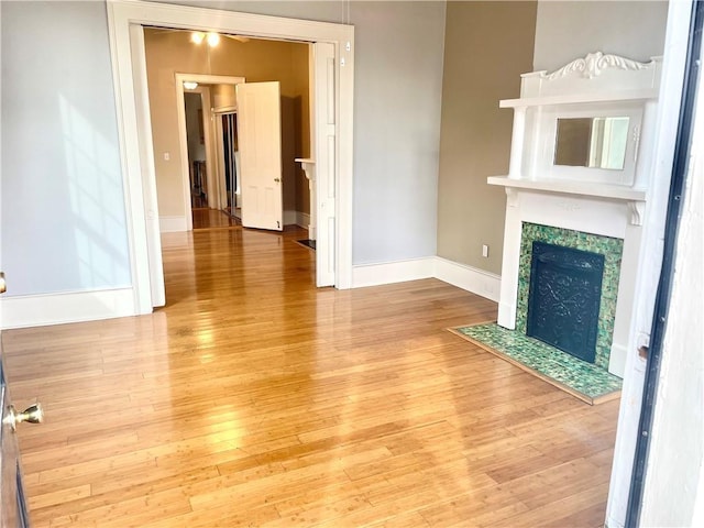 unfurnished living room featuring a fireplace and light wood-type flooring