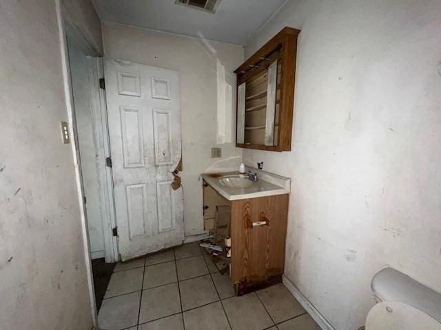 bathroom featuring vanity, tile patterned flooring, and toilet