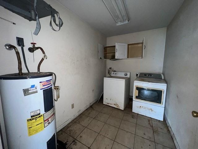 clothes washing area featuring separate washer and dryer, tile patterned flooring, and water heater