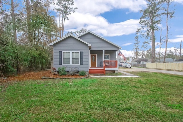 view of front of house with a front yard and a porch