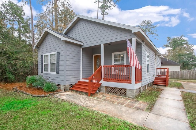 bungalow featuring a porch and a front lawn