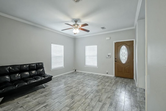 entrance foyer featuring crown molding, ceiling fan, and light wood-type flooring