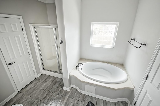 bathroom featuring independent shower and bath