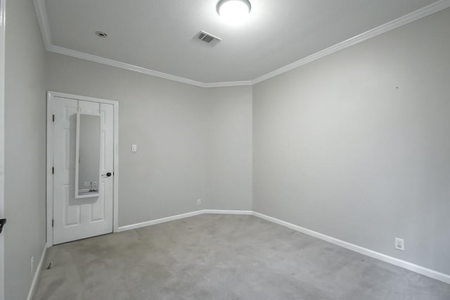 spare room featuring crown molding and carpet flooring