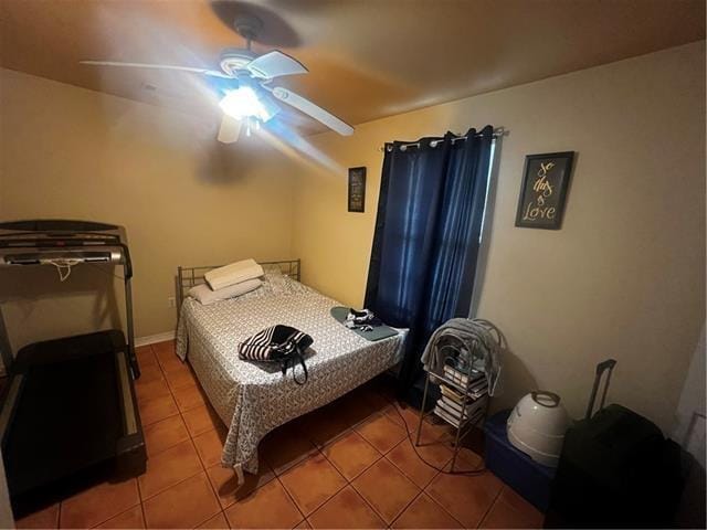 tiled bedroom with ceiling fan