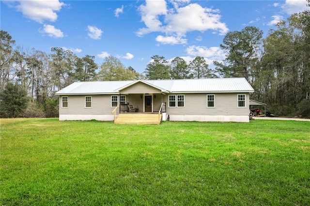 rear view of property with covered porch, metal roof, and a lawn