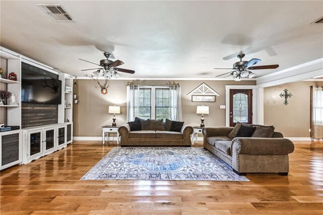 12119 Acey Allen Rd, Independence, LA 70443 - living area with a ceiling fan, baseboards, visible vents, and wood finished floors