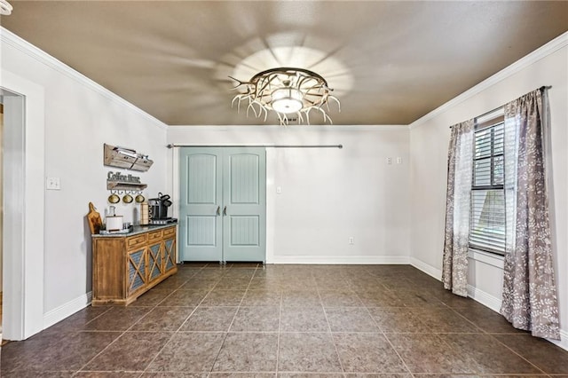 unfurnished dining area with dark tile patterned floors and ornamental molding