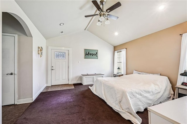 bedroom with lofted ceiling, dark carpet, and ceiling fan