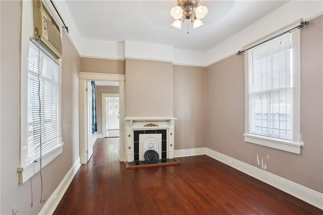 unfurnished living room featuring dark wood-type flooring and ceiling fan