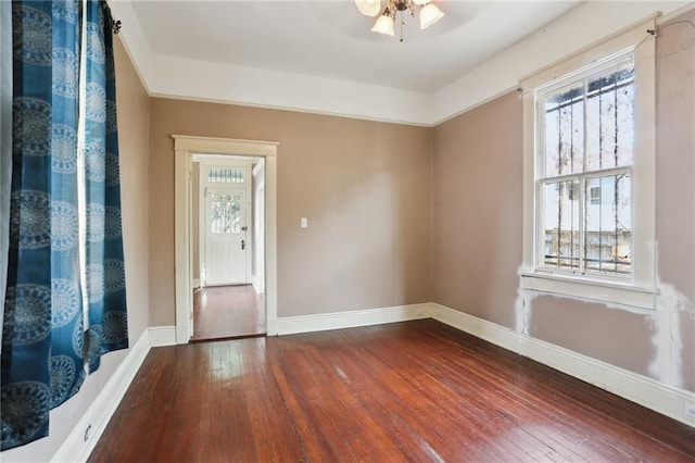 unfurnished room with wood-type flooring and ceiling fan