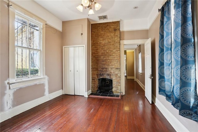 unfurnished living room featuring dark wood-type flooring and ceiling fan