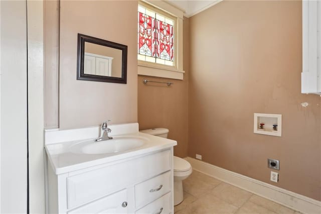 bathroom featuring vanity, tile patterned flooring, and toilet