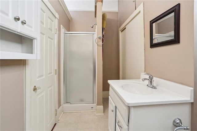 bathroom with tile patterned flooring, vanity, and walk in shower