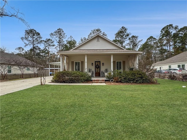 view of front of home with a front yard and a carport