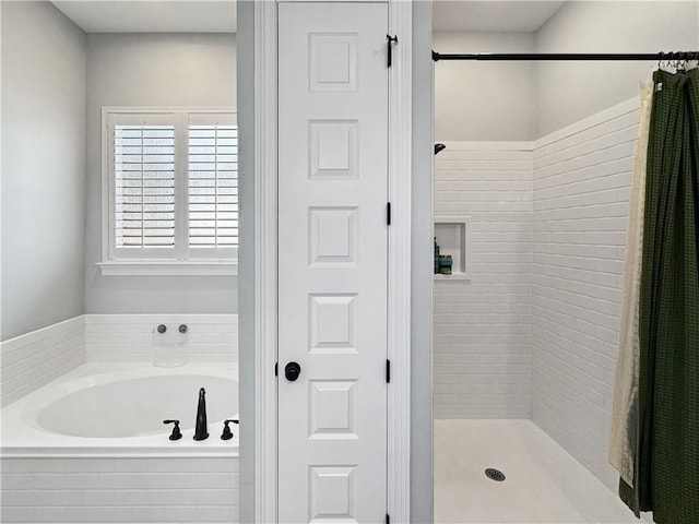 bathroom with shower with separate bathtub