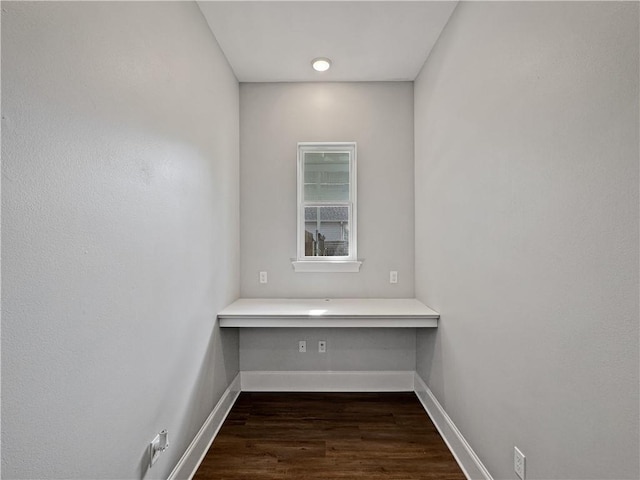 interior space with built in desk and dark hardwood / wood-style flooring