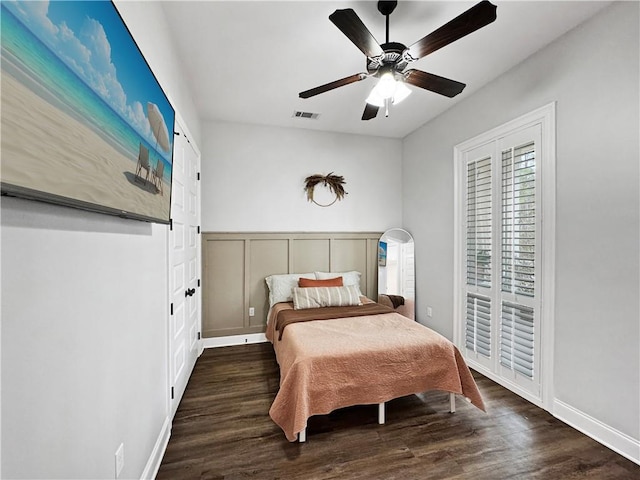 bedroom with ceiling fan and dark hardwood / wood-style flooring