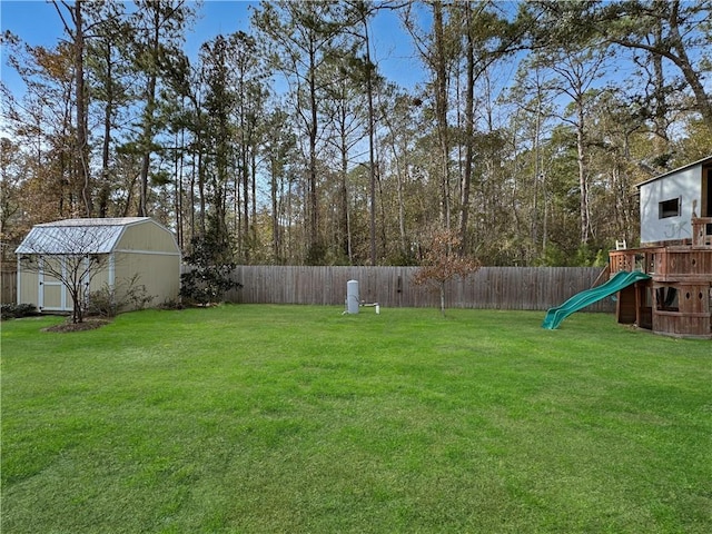 view of yard with a shed and a playground