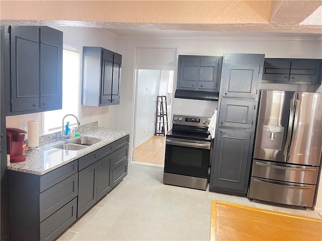 kitchen featuring light stone countertops, under cabinet range hood, ornamental molding, stainless steel appliances, and a sink