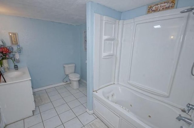 bathroom with tile patterned floors, toilet, a combined bath / shower with jetted tub, baseboards, and vanity