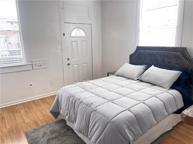 bedroom with baseboards and light wood finished floors