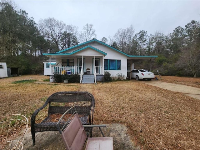 view of front of house with a porch and a carport