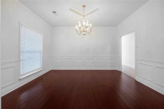 empty room featuring a chandelier, dark wood-type flooring, ornamental molding, and visible vents