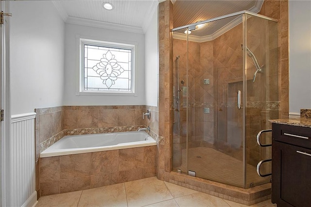 bathroom with tile patterned flooring, a garden tub, vanity, ornamental molding, and a stall shower