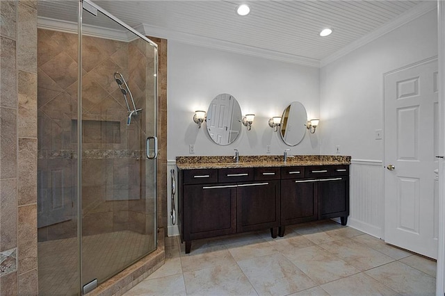 full bath featuring a wainscoted wall, ornamental molding, vanity, a shower stall, and recessed lighting