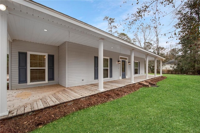 back of house with a porch and a yard