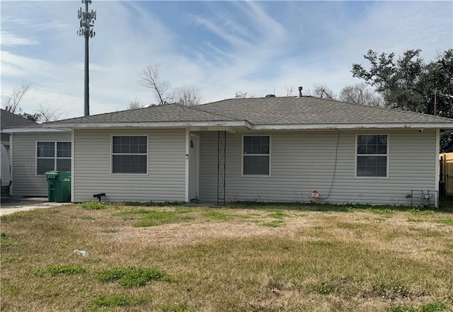 rear view of house featuring a lawn