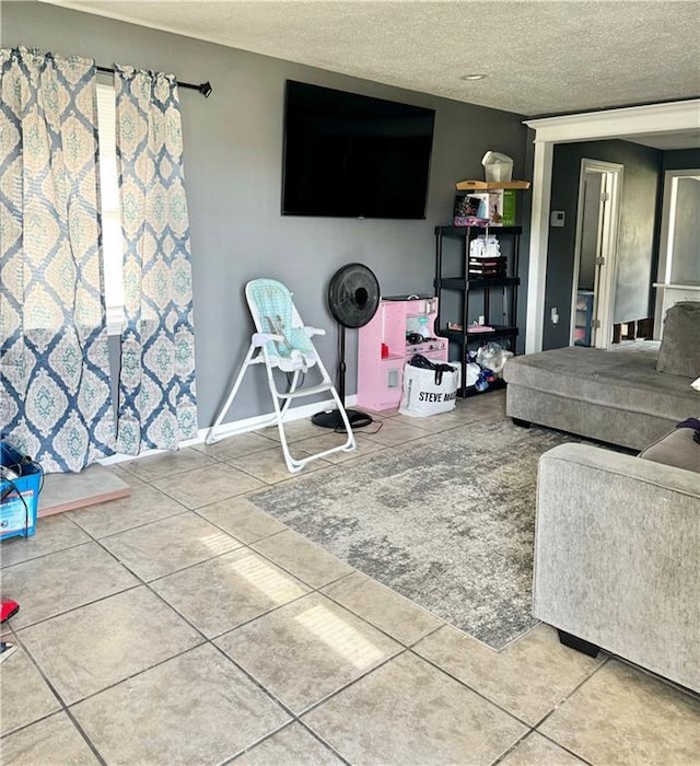 living room with tile patterned floors and a textured ceiling