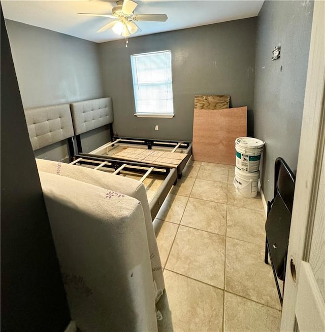 bedroom with ceiling fan and light tile patterned floors