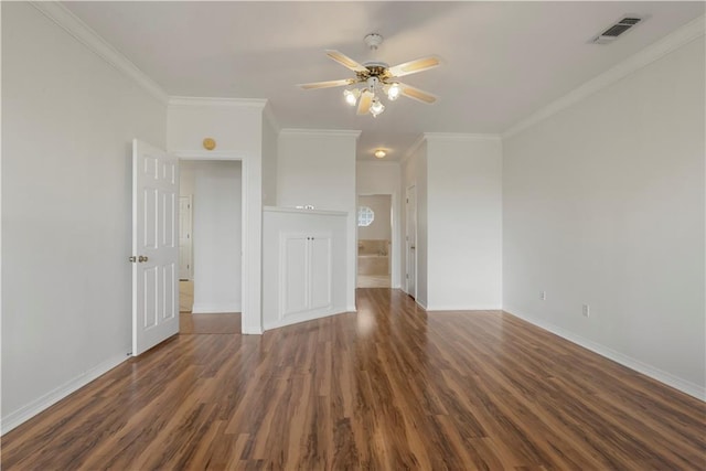 interior space featuring ornamental molding, visible vents, baseboards, and wood finished floors