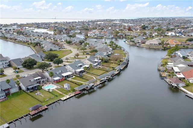 birds eye view of property with a water view and a residential view