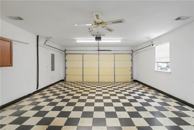 garage featuring baseboards, electric panel, visible vents, and a garage door opener