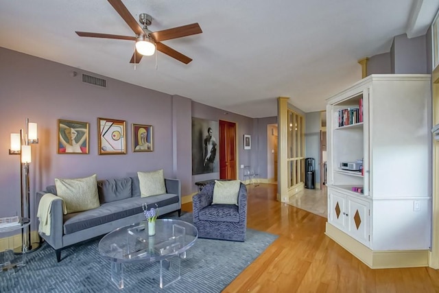 living room featuring light hardwood / wood-style flooring and ceiling fan