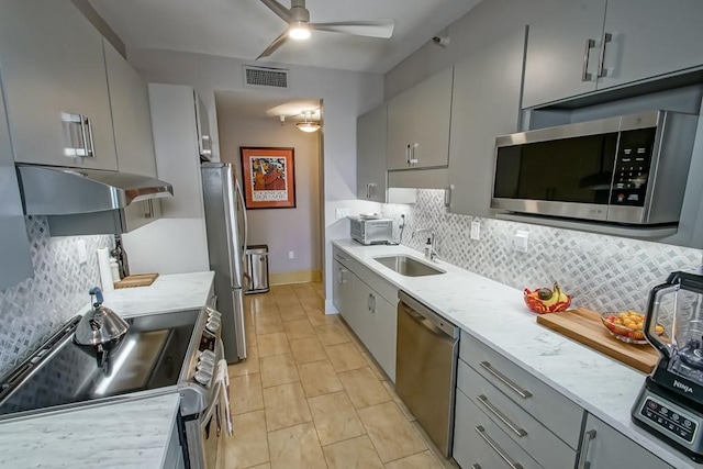 kitchen with sink, gray cabinets, and stainless steel appliances