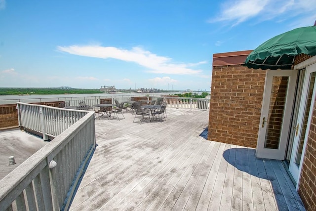 wooden deck featuring a water view