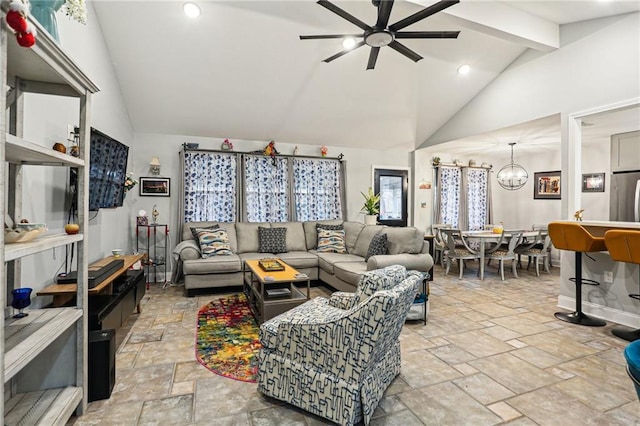 living room with lofted ceiling with beams and ceiling fan with notable chandelier