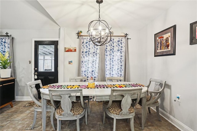 dining room featuring lofted ceiling and a chandelier