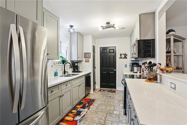 kitchen featuring gray cabinets, sink, and black appliances