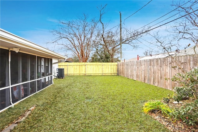 view of yard with a sunroom and central AC