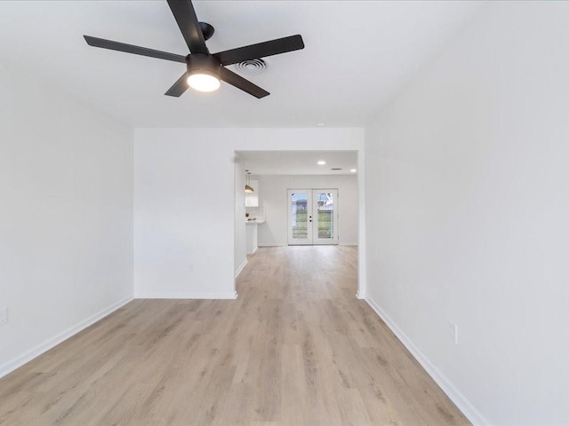 unfurnished room featuring light hardwood / wood-style flooring, french doors, and ceiling fan